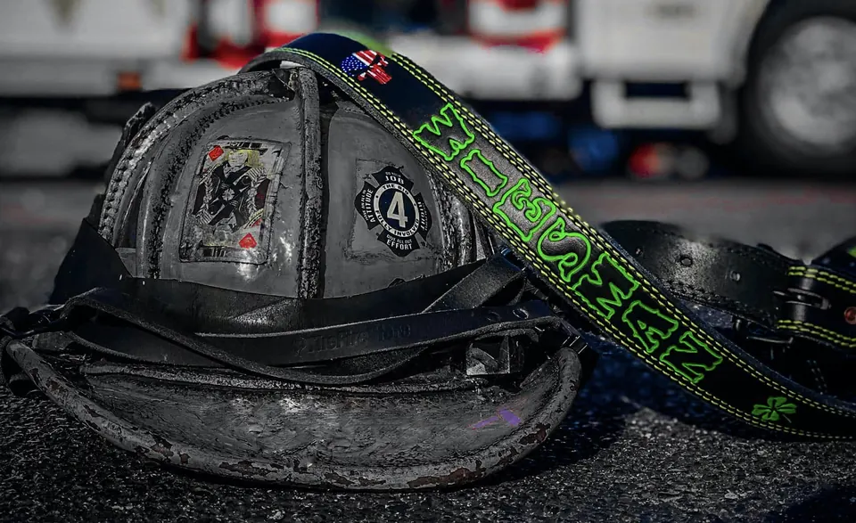 Weathered fire helmet with custom JP radio strap