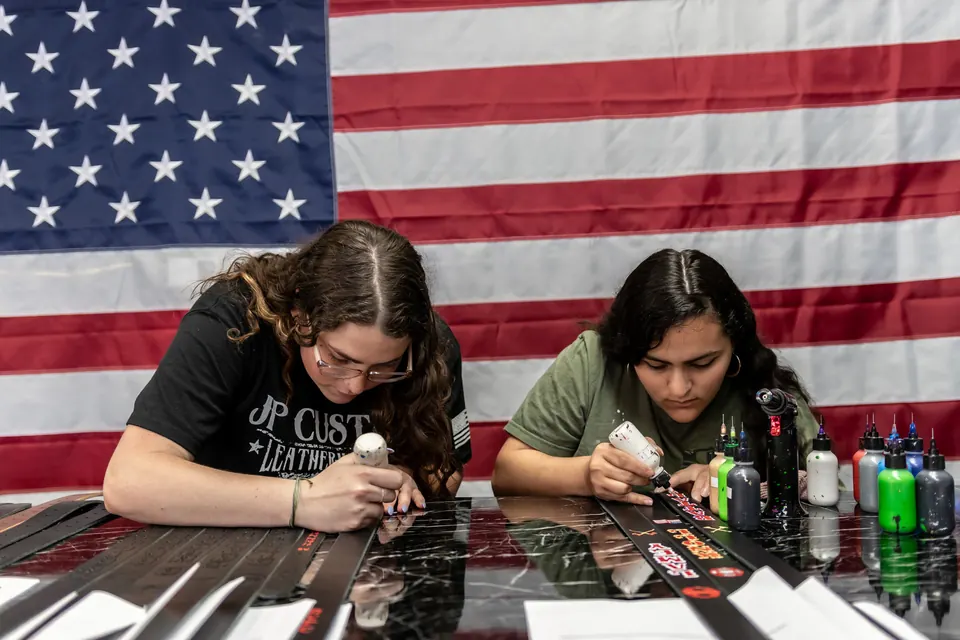 The Petito family hand-painting straps under the American flag