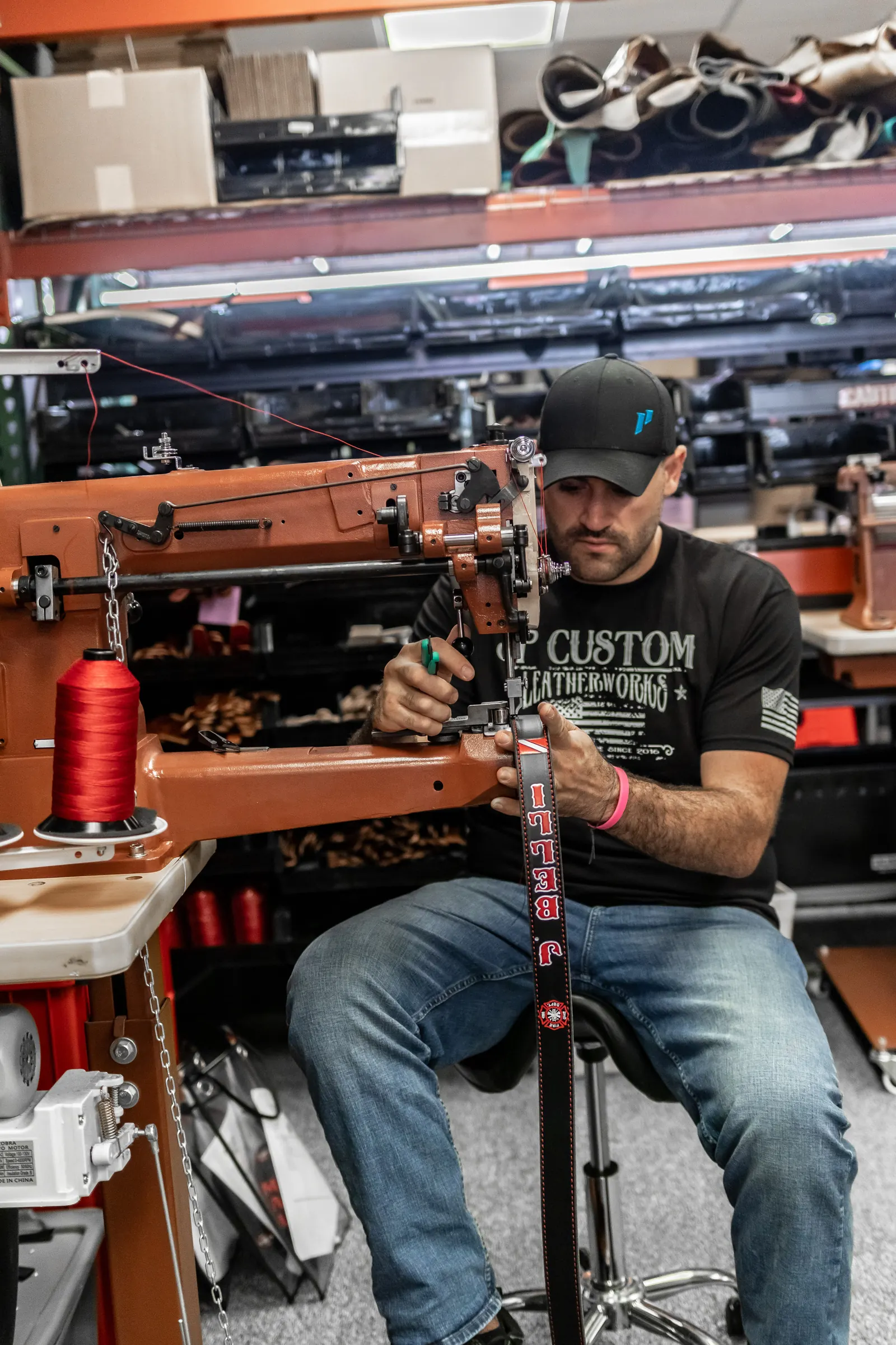Joe Petito stitching a custom radio strap on the Cobra machine